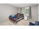 Bright bedroom with a large window, and a comfortable bed with playful patterns at 114 Oakland Rd, Belmont, NC 28012