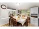 Bright dining room with wood floors, a large table, and windows providing natural light at 114 Oakland Rd, Belmont, NC 28012