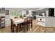Inviting dining room showcases wood floors and seamlessly connects to the modern kitchen with gray cabinets at 114 Oakland Rd, Belmont, NC 28012