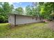 Home's exterior with vinyl siding, complemented by a well-maintained lawn and mature trees at 114 Oakland Rd, Belmont, NC 28012