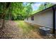 Exterior view of home with vinyl siding, showcasing the expansive backyard and an A/C unit at 114 Oakland Rd, Belmont, NC 28012