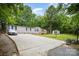 Exterior shot of home with a spacious driveway, manicured lawn, and convenient storage shed at 114 Oakland Rd, Belmont, NC 28012