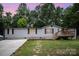 Charming home featuring an inviting entryway, well-maintained lawn, and a welcoming front deck at 114 Oakland Rd, Belmont, NC 28012