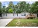 Charming home featuring an inviting entryway, well-maintained lawn, and a welcoming front deck at 114 Oakland Rd, Belmont, NC 28012