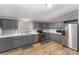 Modern kitchen with stainless steel appliances, gray cabinets, and white countertops at 114 Oakland Rd, Belmont, NC 28012