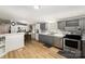 Well-lit kitchen featuring stainless steel appliances, gray cabinets, and an eat-in breakfast bar at 114 Oakland Rd, Belmont, NC 28012