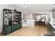Open-concept living area with wood floors, a decorative cabinet and dining room in the background at 114 Oakland Rd, Belmont, NC 28012