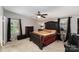 Elegant bedroom with dark wood furnishings and a decorative ceiling fan at 114 Oakland Rd, Belmont, NC 28012
