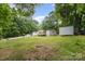 Spacious front yard featuring a home with a wooden deck, and shed perfect for outdoor enjoyment at 114 Oakland Rd, Belmont, NC 28012