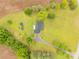 Aerial of home nestled on large lawned lot with two storage buildings and long driveway at 1162 E Doc Garris Rd, Lancaster, SC 29720