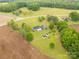 Expansive property featuring a charming home, two storage sheds and lush greenery at 1162 E Doc Garris Rd, Lancaster, SC 29720