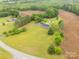 Picturesque home surrounded by green lawns, mature trees and adjacent cultivated fields at 1162 E Doc Garris Rd, Lancaster, SC 29720