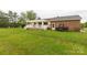 Spacious backyard with a deck, a brick home, and a parked utility vehicle at 1162 E Doc Garris Rd, Lancaster, SC 29720