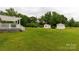 Backyard featuring a deck with pergola and two storage sheds at 1162 E Doc Garris Rd, Lancaster, SC 29720