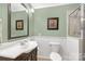This bathroom has a toilet, sink with a dark wood cabinet, and a shower at 1162 E Doc Garris Rd, Lancaster, SC 29720