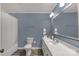 A blue bathroom featuring a toilet, sink, and shower/tub combination at 1162 E Doc Garris Rd, Lancaster, SC 29720