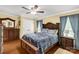 A traditional bedroom featuring hardwood floors, wood furniture, and neutral decor at 1162 E Doc Garris Rd, Lancaster, SC 29720