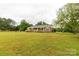Beautiful brick home featuring a covered porch, manicured lawn, and mature trees at 1162 E Doc Garris Rd, Lancaster, SC 29720