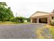 Detached two-car garage with a gravel driveway and a shaded pergola at 1162 E Doc Garris Rd, Lancaster, SC 29720