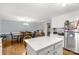 Spacious kitchen and dining area featuring white cabinets, stainless appliances, and hardwood floors at 1162 E Doc Garris Rd, Lancaster, SC 29720