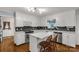 Well-lit kitchen with white cabinets, stainless steel appliances, and island with bar seating at 1162 E Doc Garris Rd, Lancaster, SC 29720