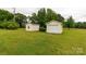 Exterior of the two storage sheds in the backyard, surrounded by green grass at 1162 E Doc Garris Rd, Lancaster, SC 29720