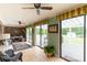 Sunroom featuring tiled floors, multiple sliding glass doors and ceiling fans at 1162 E Doc Garris Rd, Lancaster, SC 29720