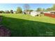 Expansive backyard featuring a storage shed and lush green lawn, perfect for outdoor activities at 123 Cross Creek Dr, Statesville, NC 28625
