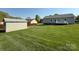 View of the backyard showing the storage shed, fenced perimeter, and access to the home with a small deck at 123 Cross Creek Dr, Statesville, NC 28625
