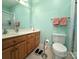 Well-lit bathroom featuring a vanity, toilet, and shower, designed for comfort and functionality at 123 Cross Creek Dr, Statesville, NC 28625