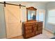 Bedroom featuring a barn door, dresser with a mirror, and a serene ambiance for restful nights at 123 Cross Creek Dr, Statesville, NC 28625