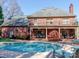 Spacious backyard featuring a large in-ground pool and a brick home at 1233 Weymouth Ln, Charlotte, NC 28270