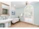 Elegant bathroom featuring a clawfoot tub, single sink, and arched window at 1233 Weymouth Ln, Charlotte, NC 28270