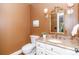 Charming powder room with granite countertop, decorative mirror, and classic fixtures at 1233 Weymouth Ln, Charlotte, NC 28270