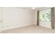 Minimalist bedroom with bright windows and striped curtains at 1233 Weymouth Ln, Charlotte, NC 28270
