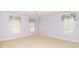 Inviting bedroom with three windows adorned with valances and a ceiling fan at 1233 Weymouth Ln, Charlotte, NC 28270