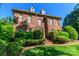 Charming brick home with dormers, manicured hedges, and a well-maintained lawn at 1233 Weymouth Ln, Charlotte, NC 28270