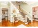 Inviting foyer featuring hardwood floors, staircase, and view into other rooms at 1233 Weymouth Ln, Charlotte, NC 28270