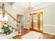 Grand foyer with hardwood floors, chandelier, and elegant staircase at 1233 Weymouth Ln, Charlotte, NC 28270