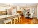 Open kitchen and dining area with granite countertops, stainless appliances, and ample seating at 1233 Weymouth Ln, Charlotte, NC 28270