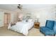 Spacious main bedroom featuring two bedside tables, art, ceiling fan, and a seating area at 1233 Weymouth Ln, Charlotte, NC 28270