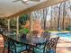This outdoor dining area features an ornate table, a ceiling fan, and poolside seating at 1233 Weymouth Ln, Charlotte, NC 28270