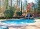 This serene backyard boasts a pool with a beautiful waterfall feature and landscaping at 1233 Weymouth Ln, Charlotte, NC 28270