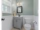 Charming half bathroom with wainscoting, updated vanity, and stylish fixtures at 14220 Stewarts Bend Ln, Charlotte, NC 28277