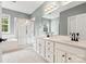 Bathroom featuring double vanity, framed mirrors, and walk-in glass shower at 14220 Stewarts Bend Ln, Charlotte, NC 28277