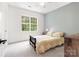 Cozy bedroom with soft carpet, natural lighting, and relaxing atmosphere at 14220 Stewarts Bend Ln, Charlotte, NC 28277