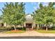 Exterior of community clubhouse with well-maintained landscaping and covered entrance at 14220 Stewarts Bend Ln, Charlotte, NC 28277