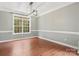 Bright dining room with hardwood floors, and a stylish modern lighting fixture above at 14220 Stewarts Bend Ln, Charlotte, NC 28277