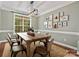 Dining room features a table and chairs with a large window and modern lighting at 14220 Stewarts Bend Ln, Charlotte, NC 28277