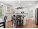 Beautiful kitchen with white cabinets, stainless steel appliances, a butcher block island, and hardwood floors at 14220 Stewarts Bend Ln, Charlotte, NC 28277
